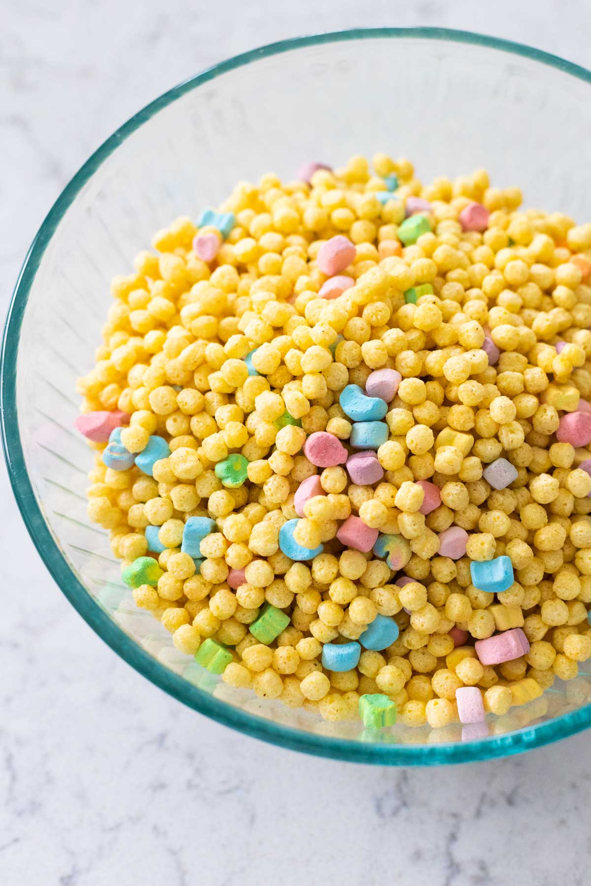 A big mixing bowl of Lucky Charms Minis cereal. 