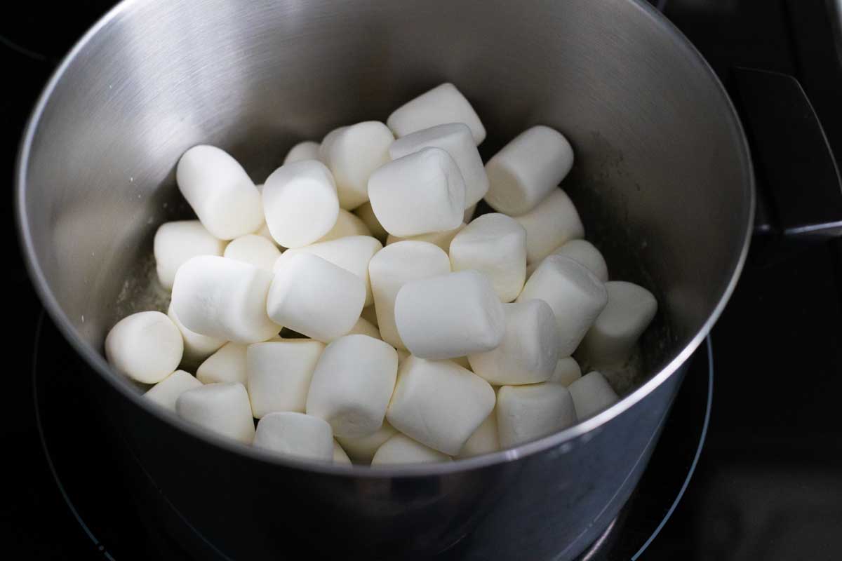 The large pot has marshmallows melting inside.