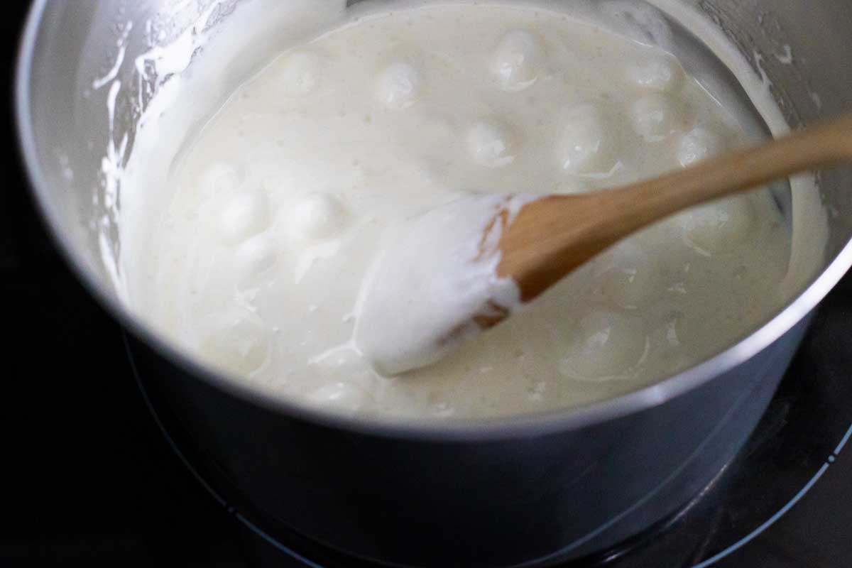 The melted marshmallows are almost ready to have the cereal stirred in.