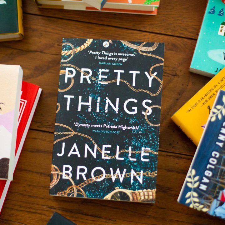 A copy of Pretty Things by Janelle Brown sits on a table.