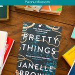 A copy of Pretty Things by Janelle Brown sits on the table.