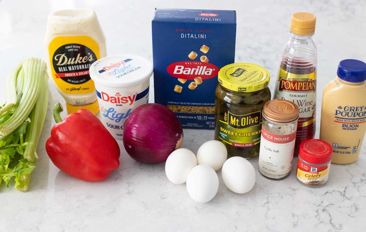 The ingredients to make the pasta salad are on the counter.
