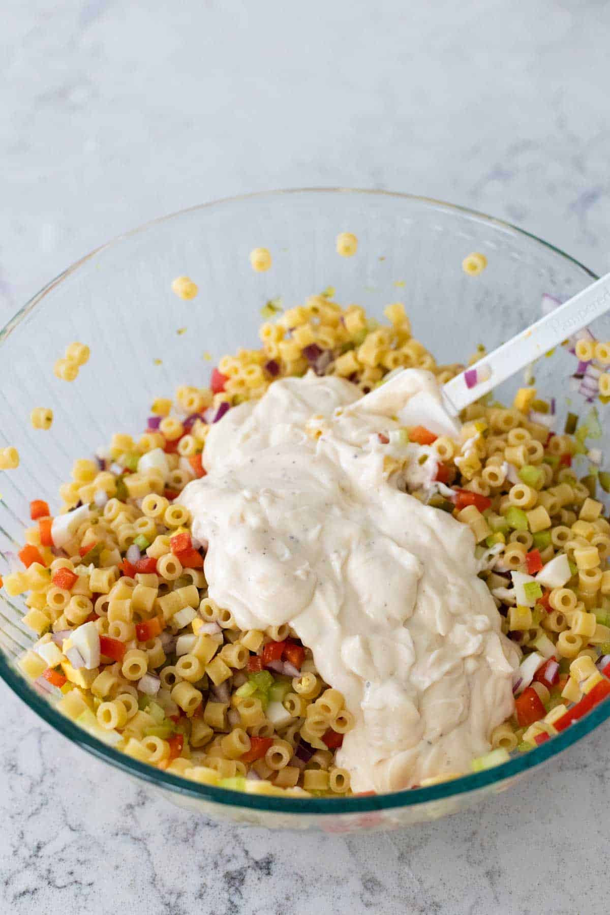 The dressing has been poured over the macaroni.