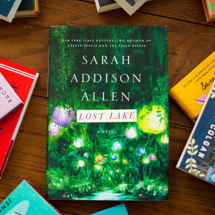 A copy of Lost Lake by Sarah Addison Allen sits on a table.