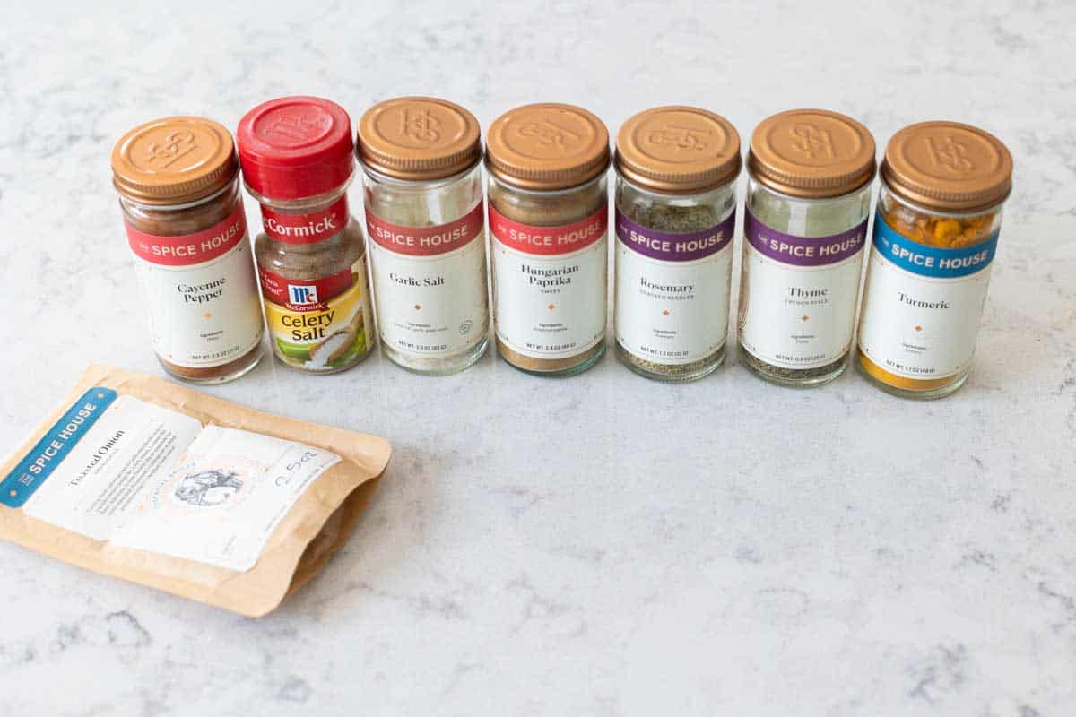 The individual spice jars are lined up on the counter.