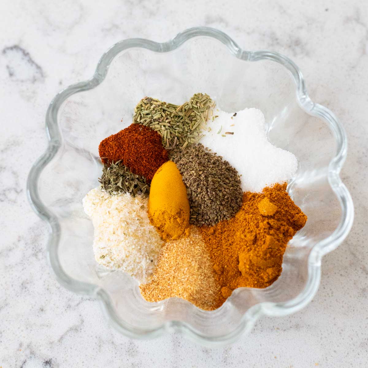 The individual spices have been measured and placed in a small bowl.