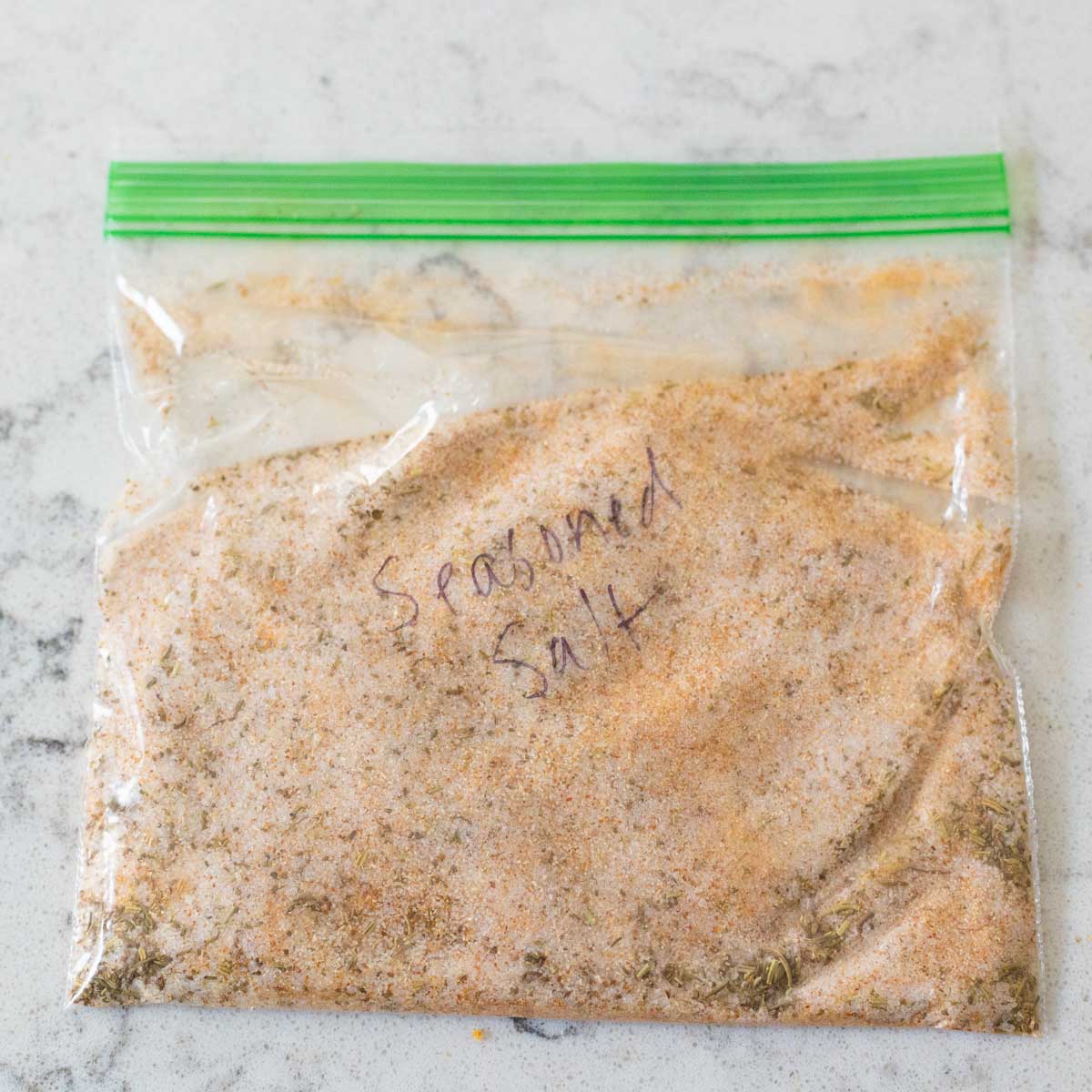 A plastic zip top baggie is labeled "Seasoned Salt" and has the salt inside.