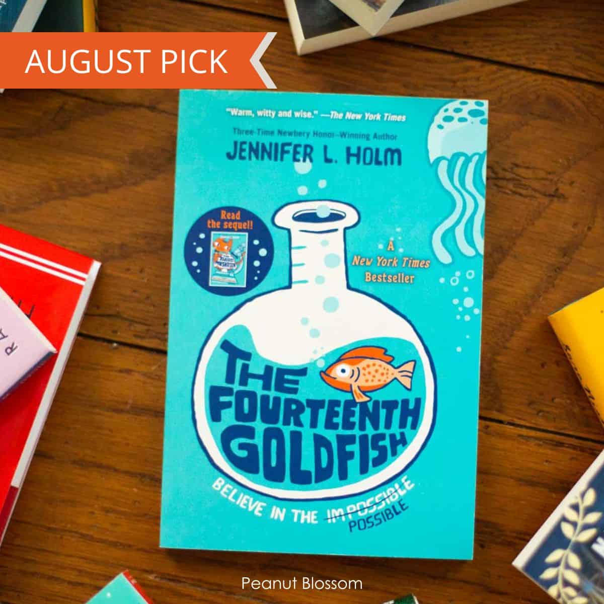 A copy of The Fourteenth Goldfish by Jennifer L. Holm sits on a table.