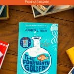 A copy of The Fourteenth Goldfish by Jennifer L. Holm sits on a table.