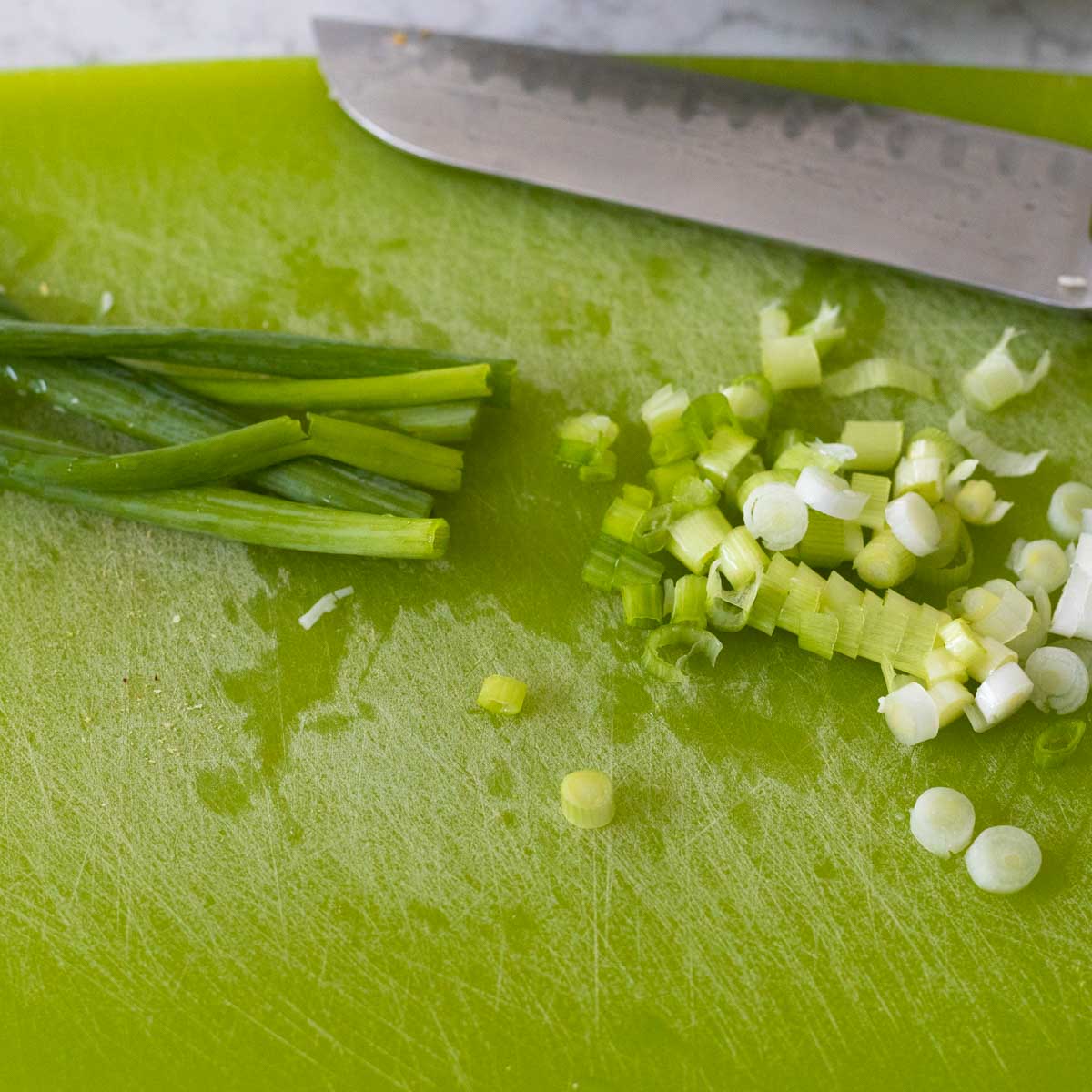 The white and green parts of the green onion have been separated and chopped.