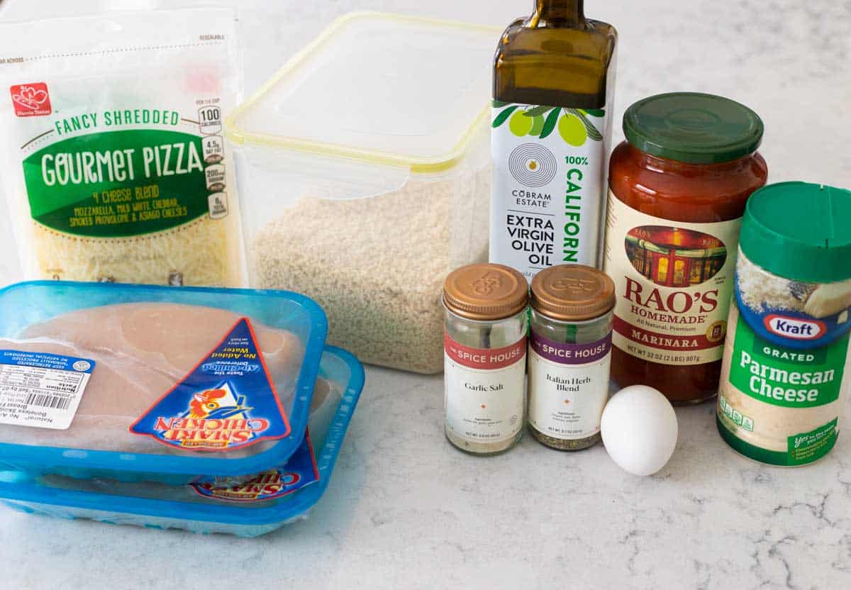 The ingredients to make chicken parmesan are on the counter.