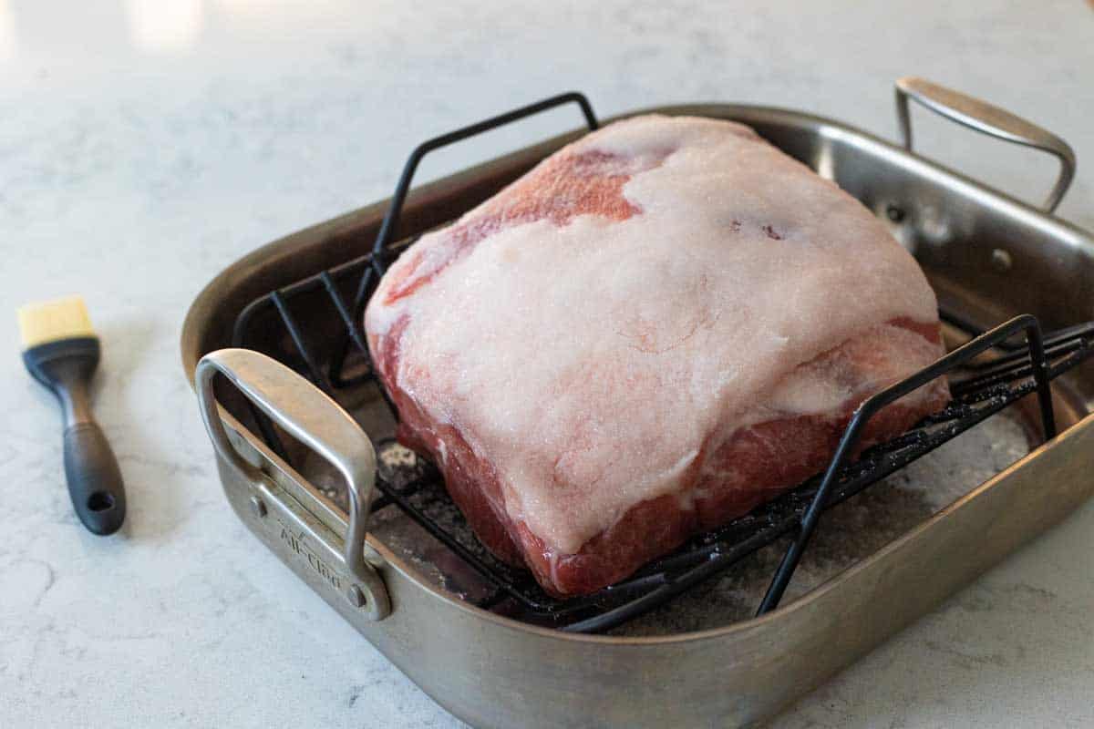 The pork shoulder has been brushed mostly clean from all the salt.