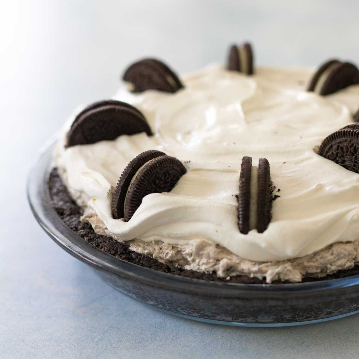 An Oreo cookie pie has an oreo cookie crust with oreo cookie filling and oreos on top.