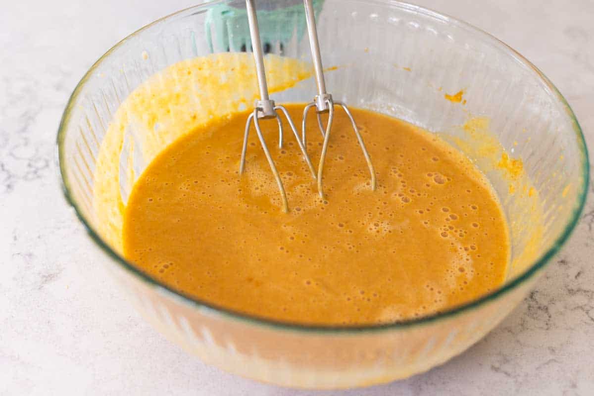 The pumpkin pie filling now has the evaporated milk drizzled in.
