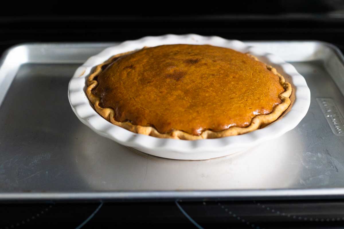 The baked pie is out of the oven, you can see the slightly puffed up center.