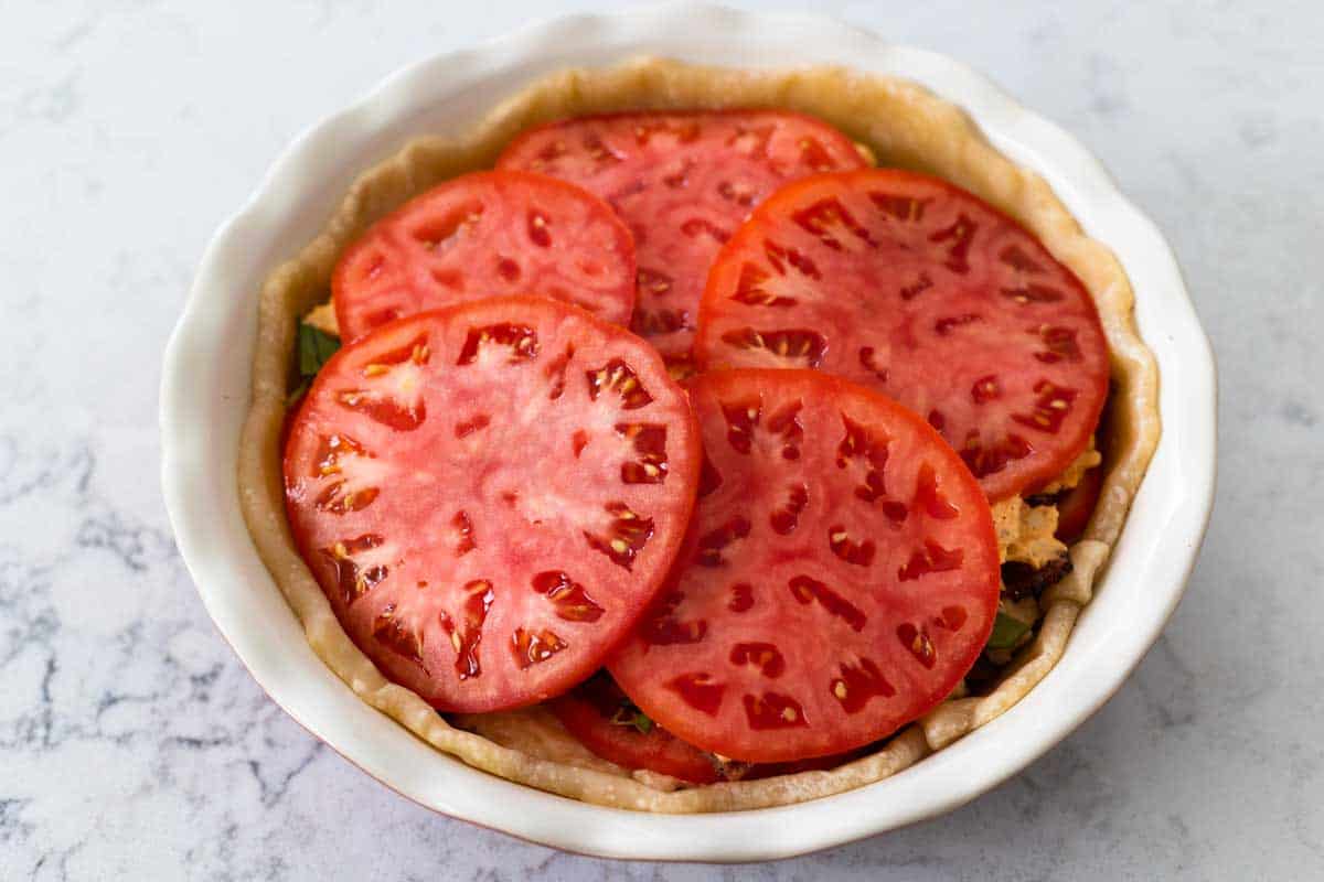 The fully assembled tomato pie is ready to be baked.