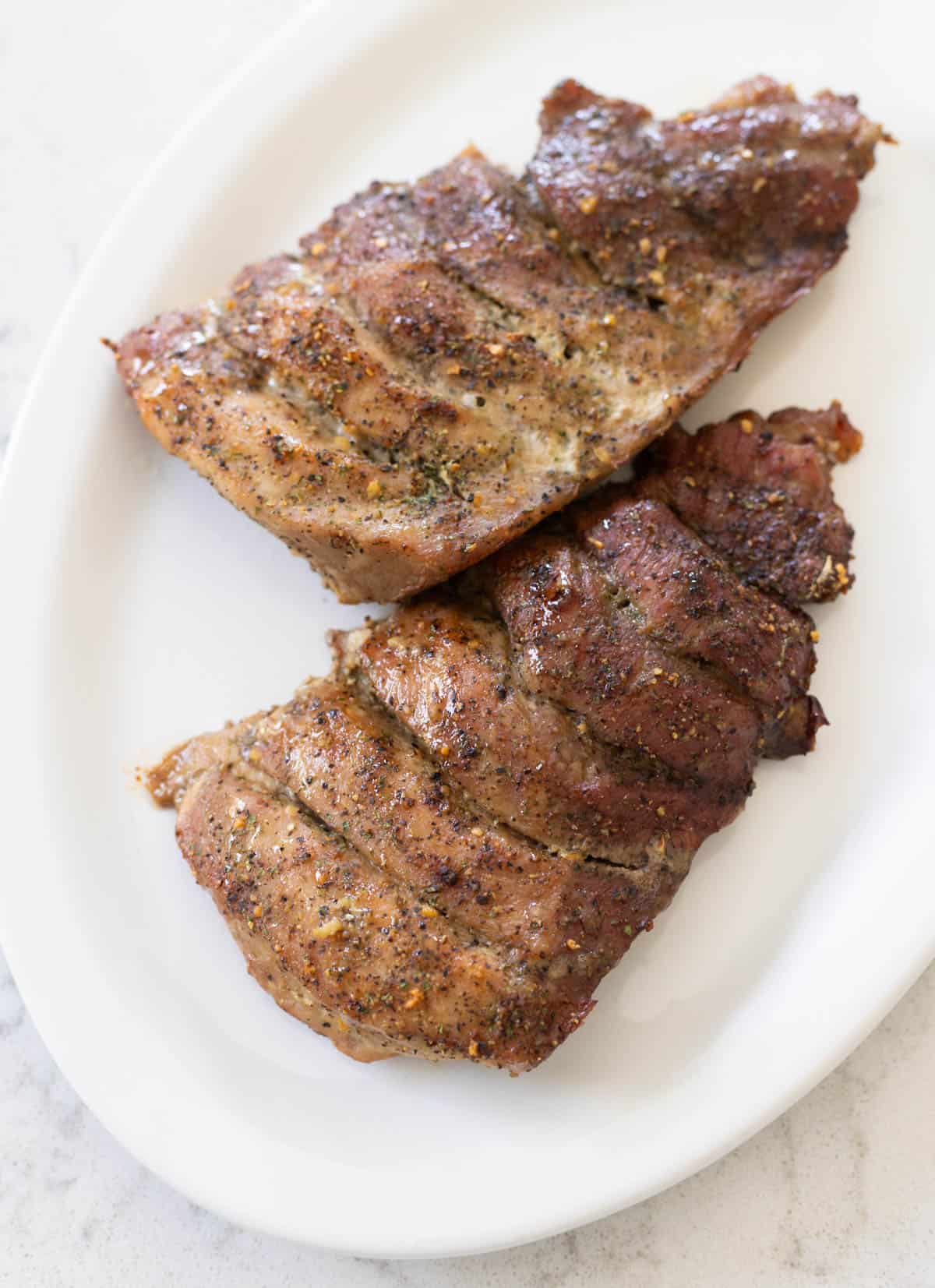 The boneless ribs are on a white serving platter ready to be enjoyed for dinner.