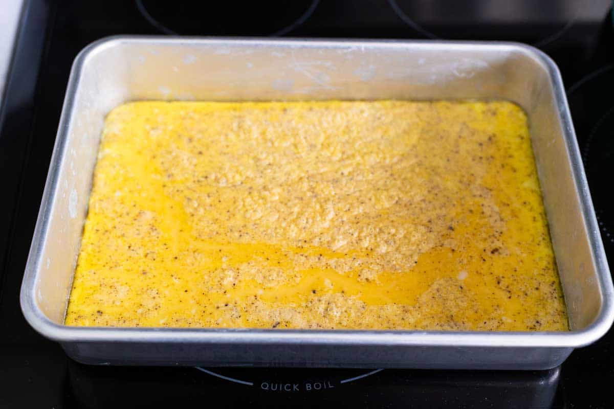 The eggs have been baked and are a solid patty on the bottom of the baking pan.