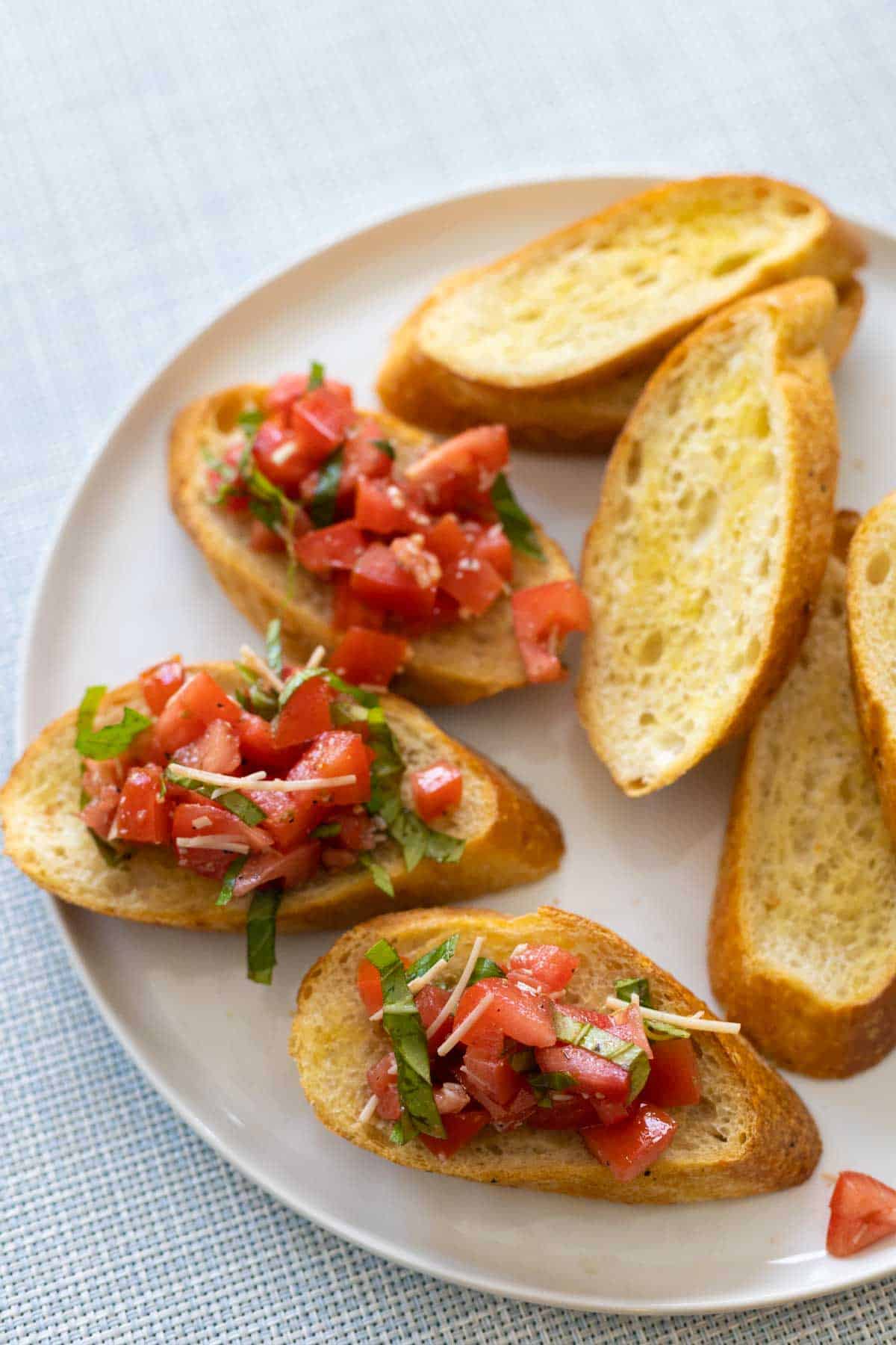 The bruschetta pomodoro is being served on golden crostini.