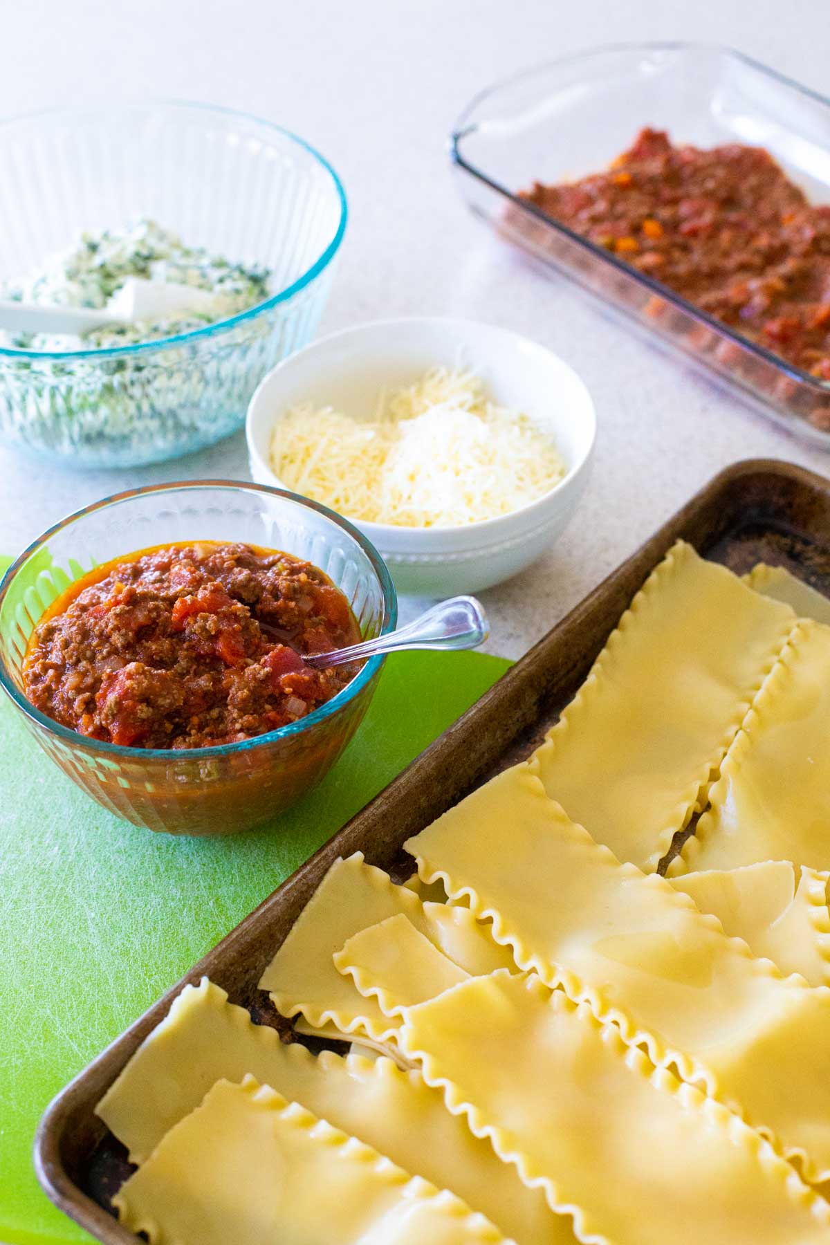 The ingredients to make the lasagna roll-ups are assembled on the counter.