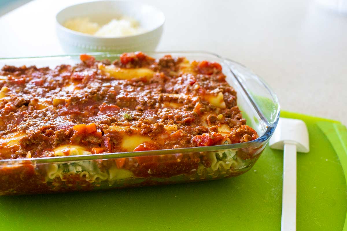 The lasagna roll-ups now have a meaty tomato sauce spooned over the top.