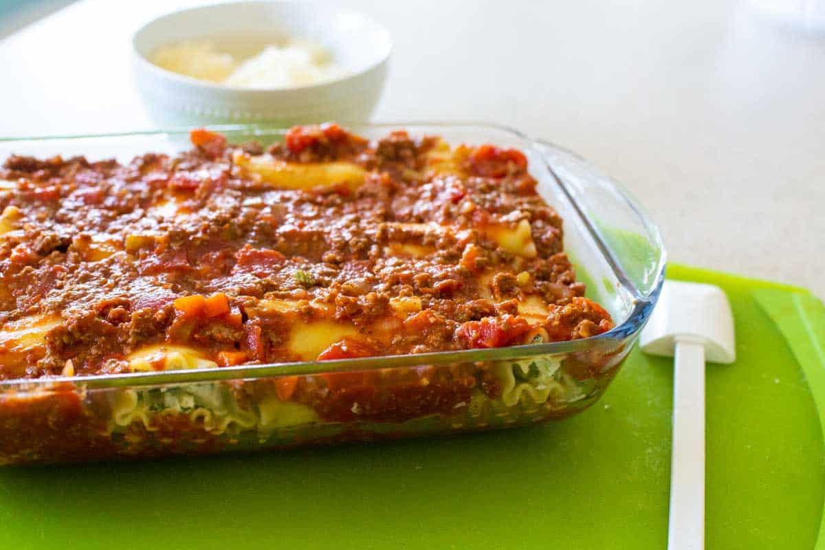 The lasagna roll-ups now have a meaty tomato sauce spooned over the top.