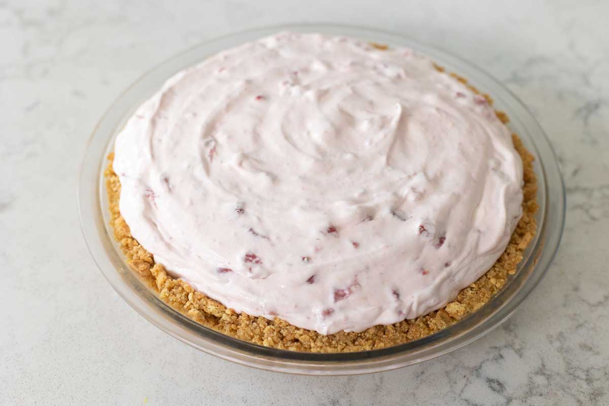 The graham cracker crust is filled with strawberry cream.