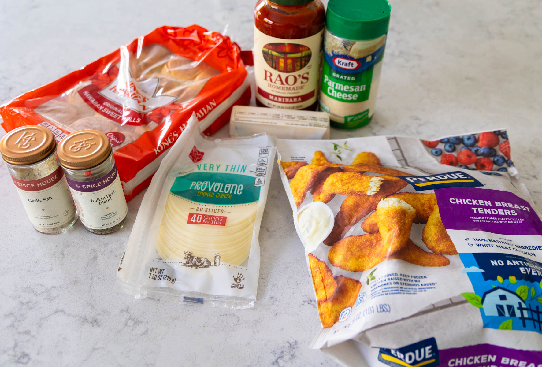 The ingredients to make chicken parm sliders are on the counter.