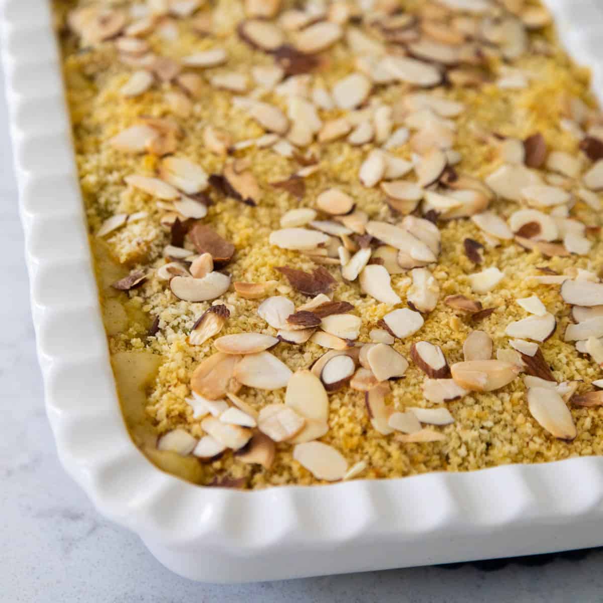 The baked chicken wild rice casserole has golden brown crumbs on top and toasted almonds.