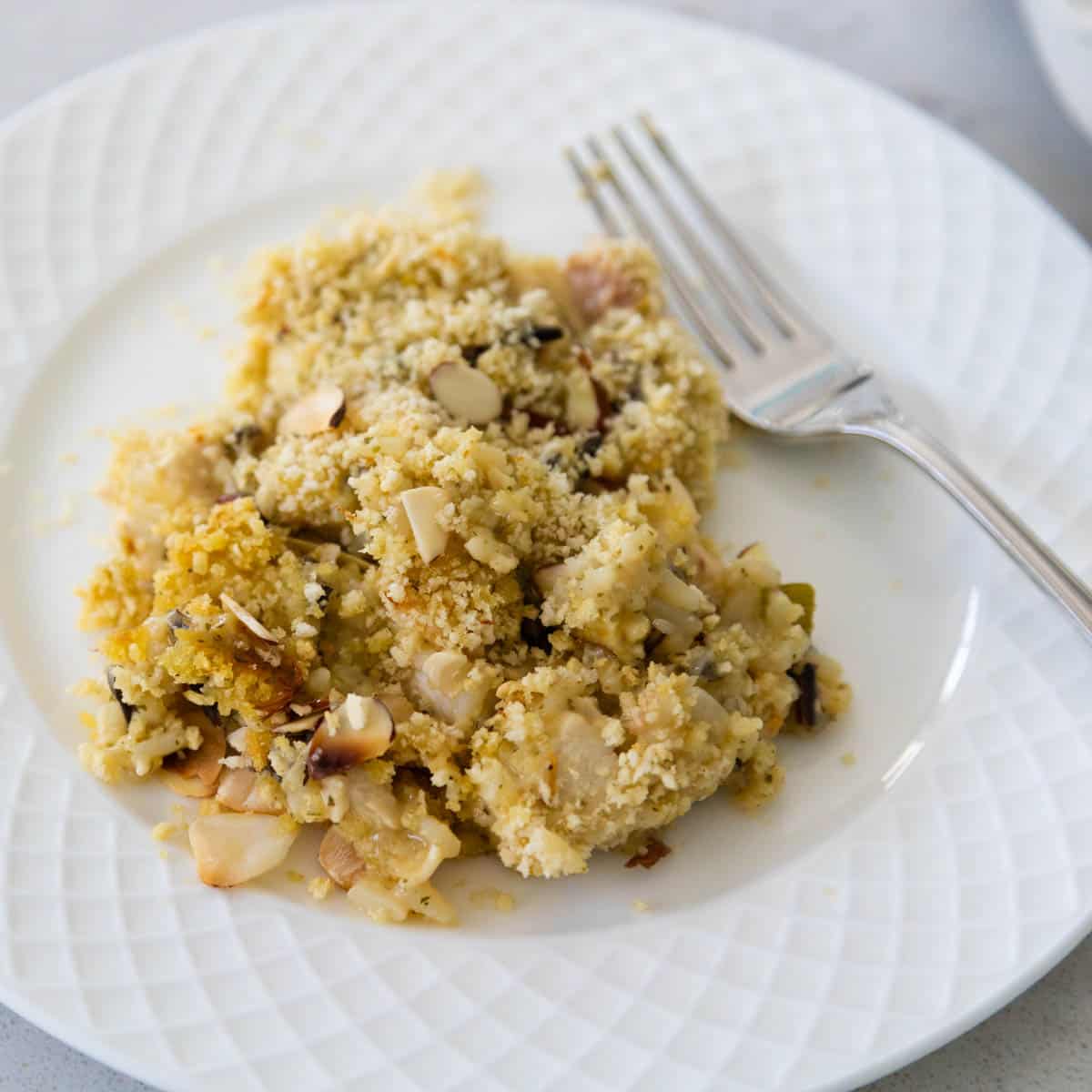 A white plate has a scoop of the finished chicken casserole on top.