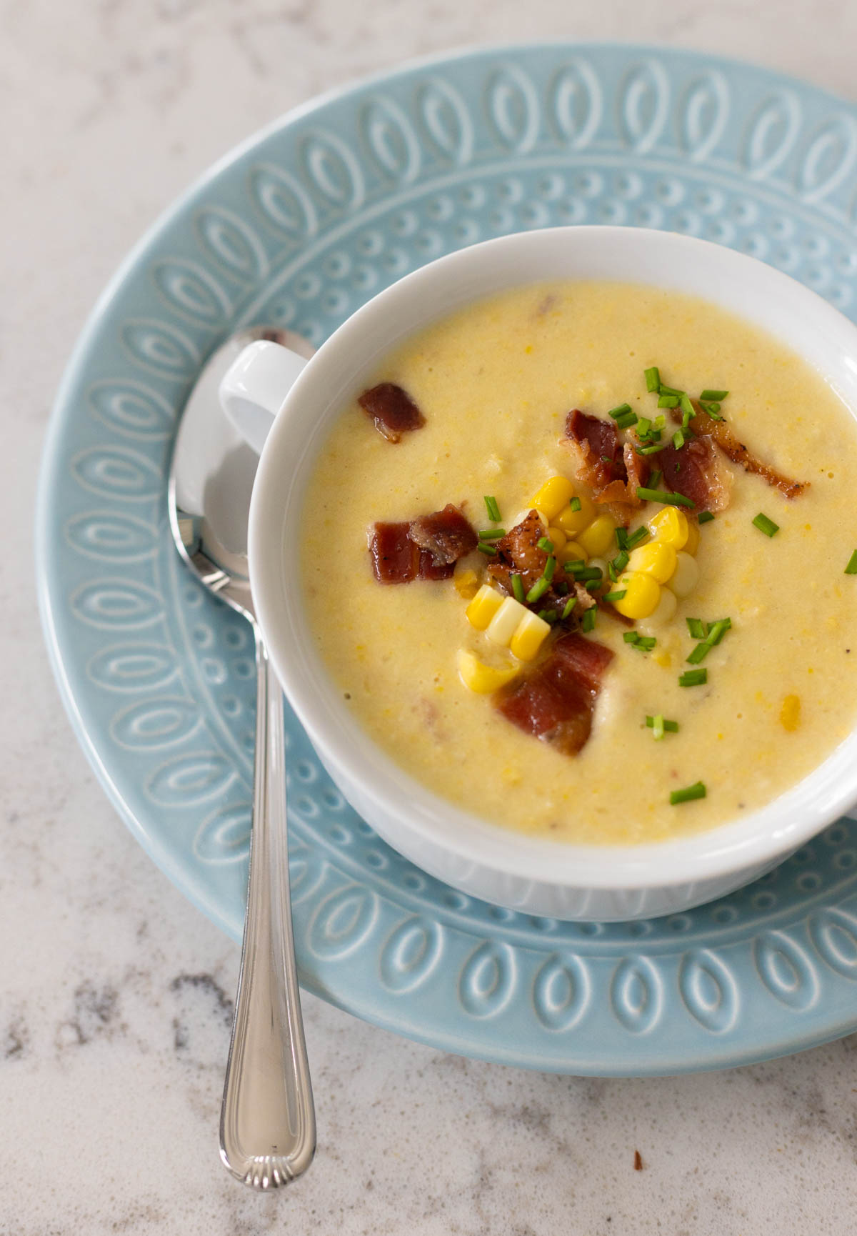 The bird's eye view of the corn chowder shows the chopped bacon and chunks of corn used as garnish.