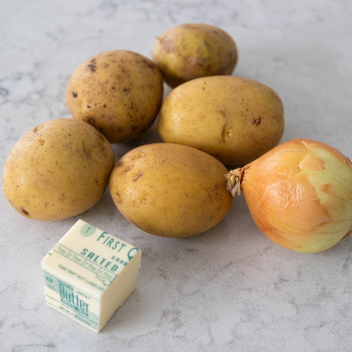 The yukon gold potatoes, an onion, and a cube of butter.