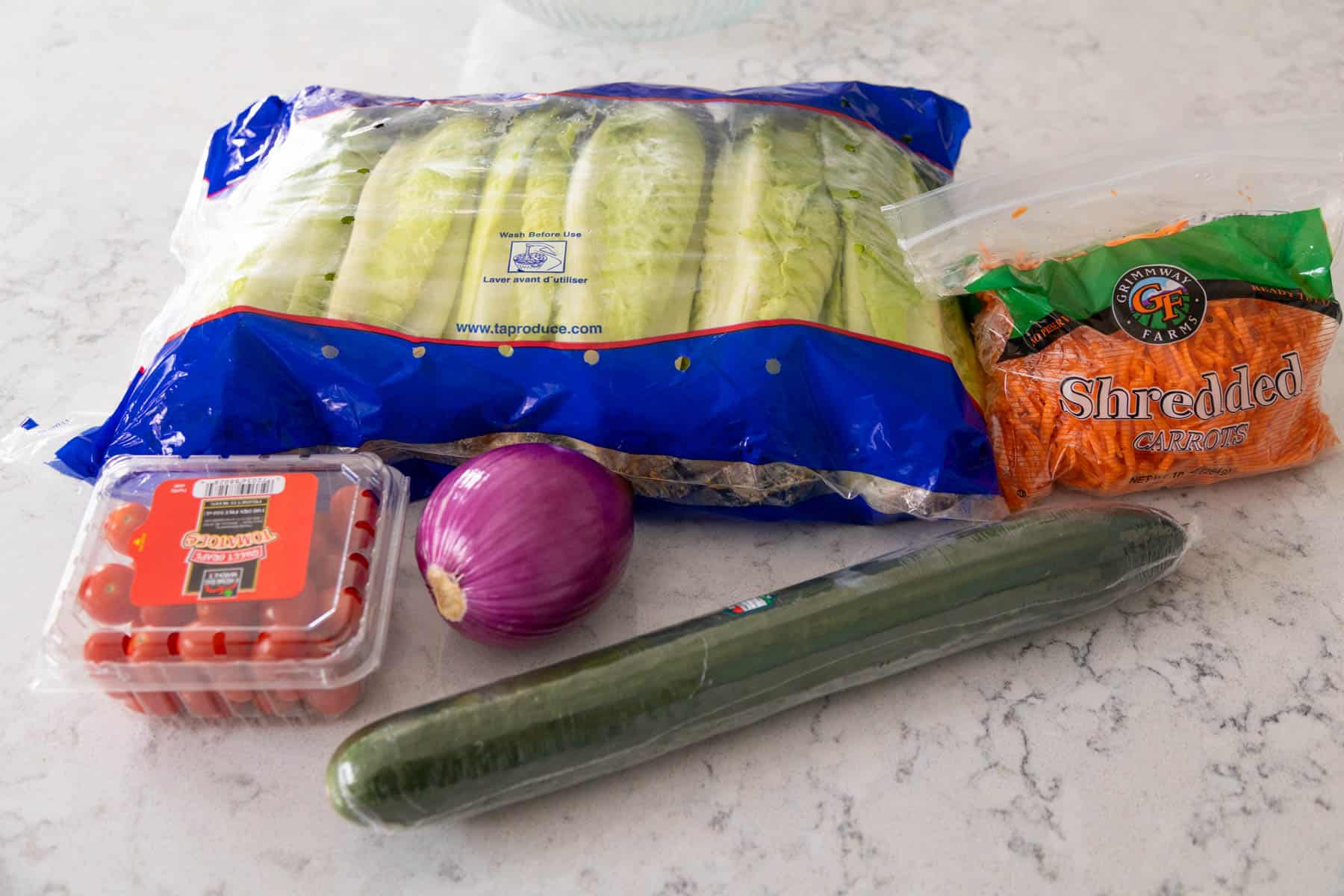 The vegetables to make the easy garden salad are on the counter.