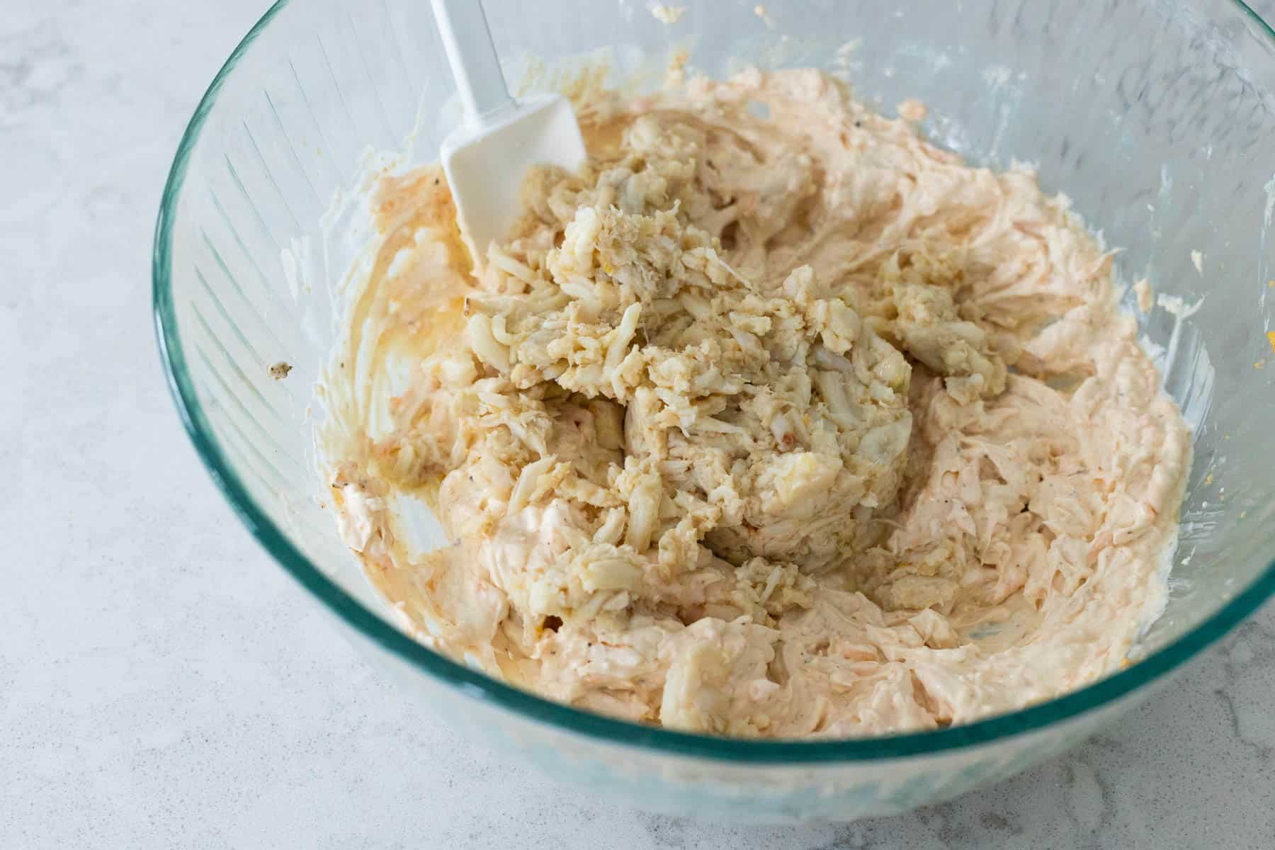 The crab meat has been added to the sauce and is about to be gently folded in.