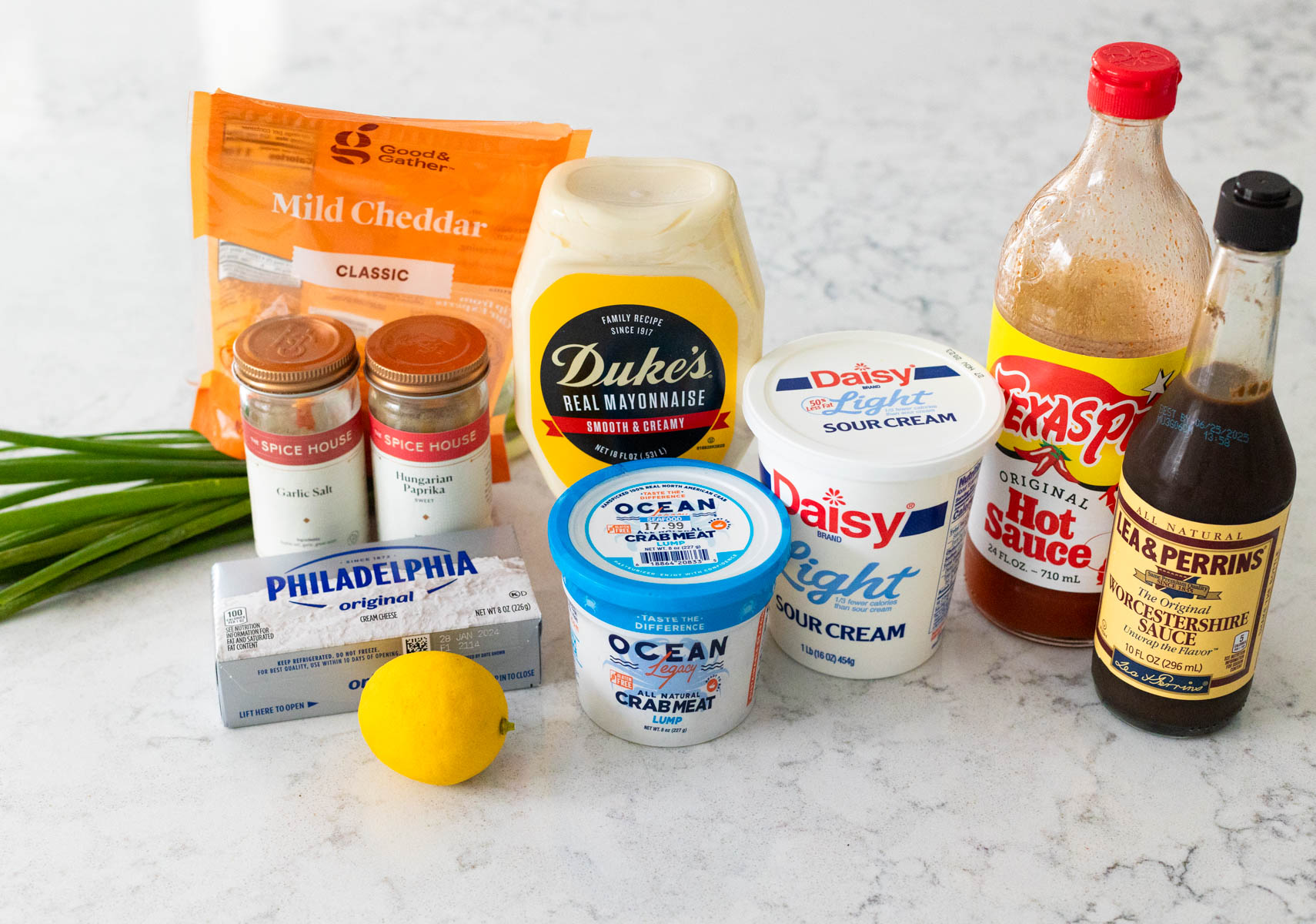 The ingredients to make hot crab dip are on the counter.