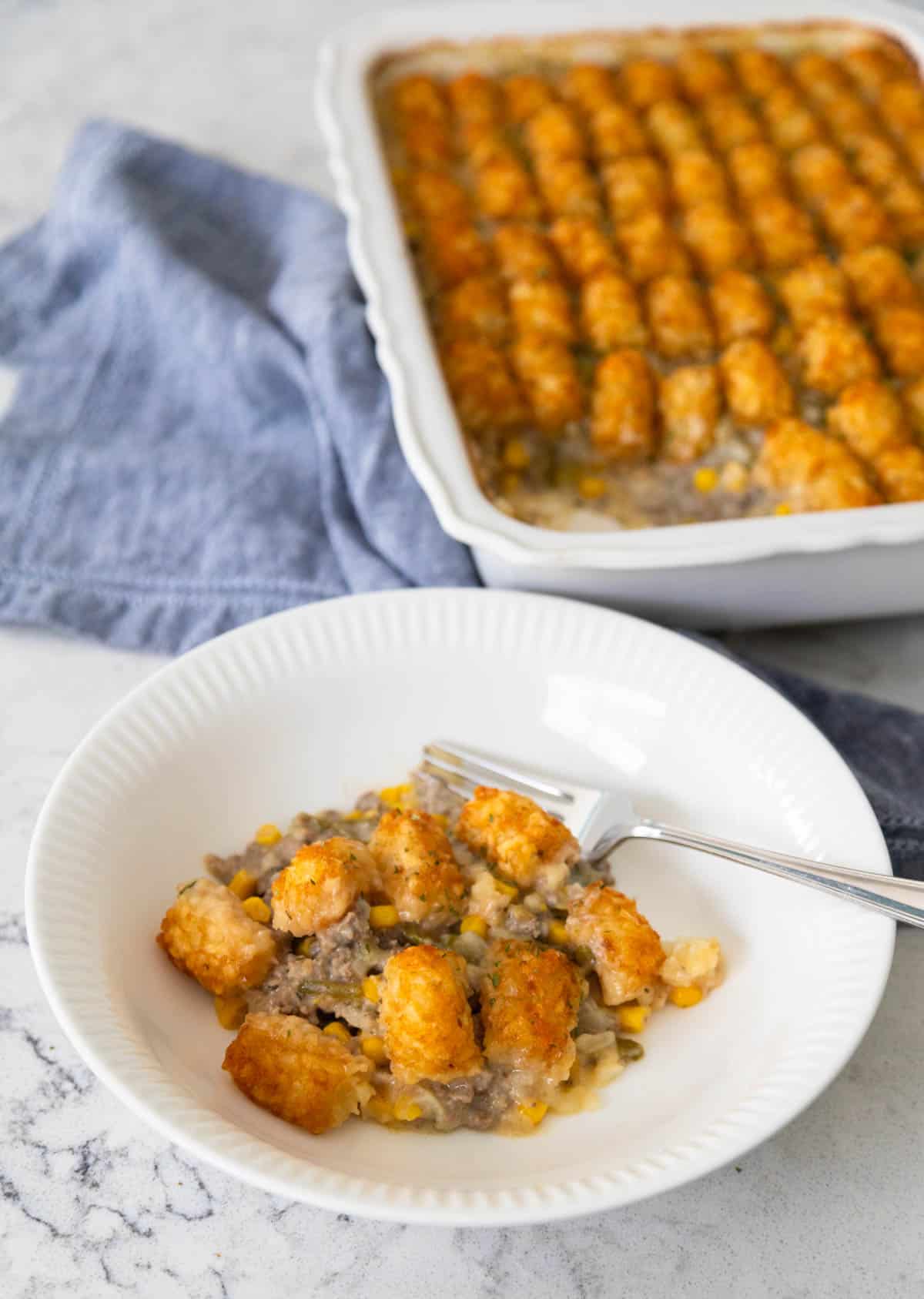 The casserole has been served in a white bowl. 