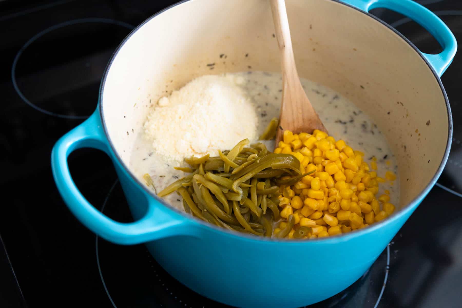 The canned vegetables have been added to the ground beef mixture.