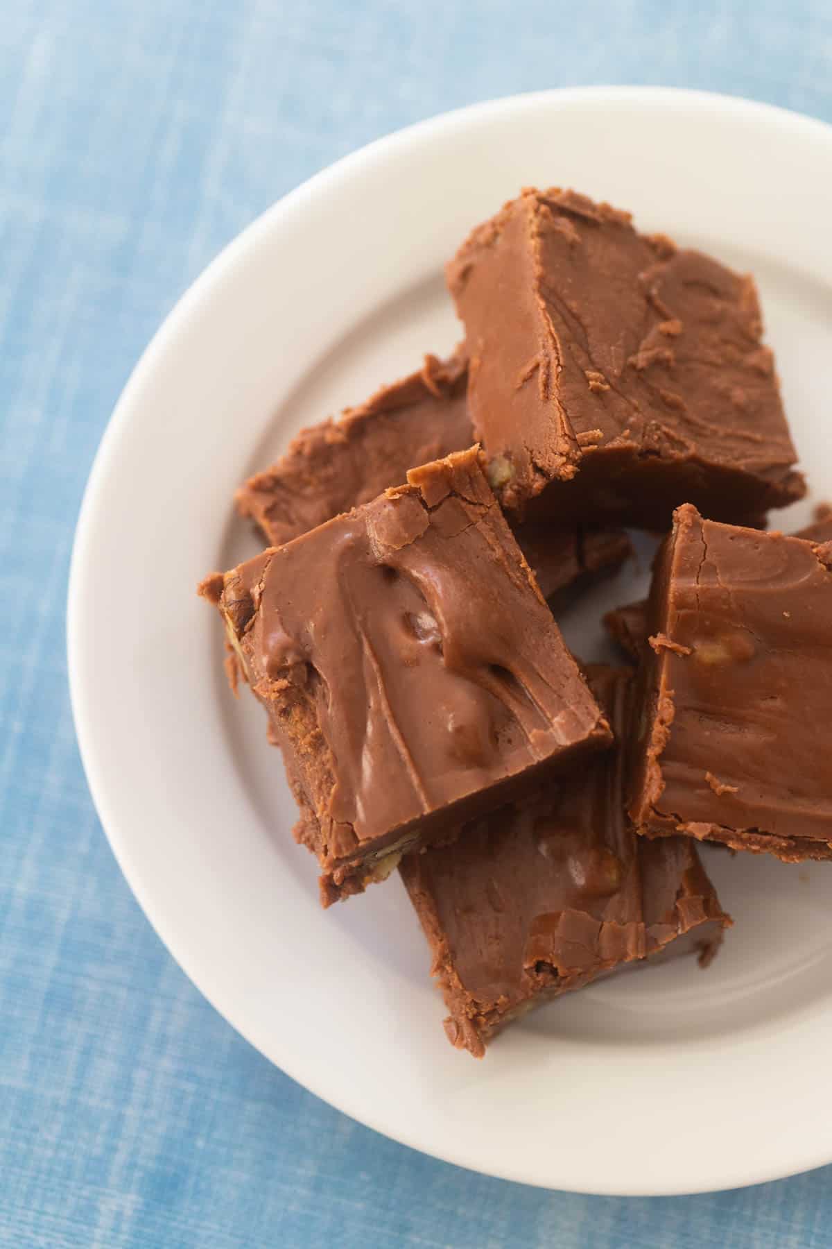 The fudge squares are on a white plate ready to be served.