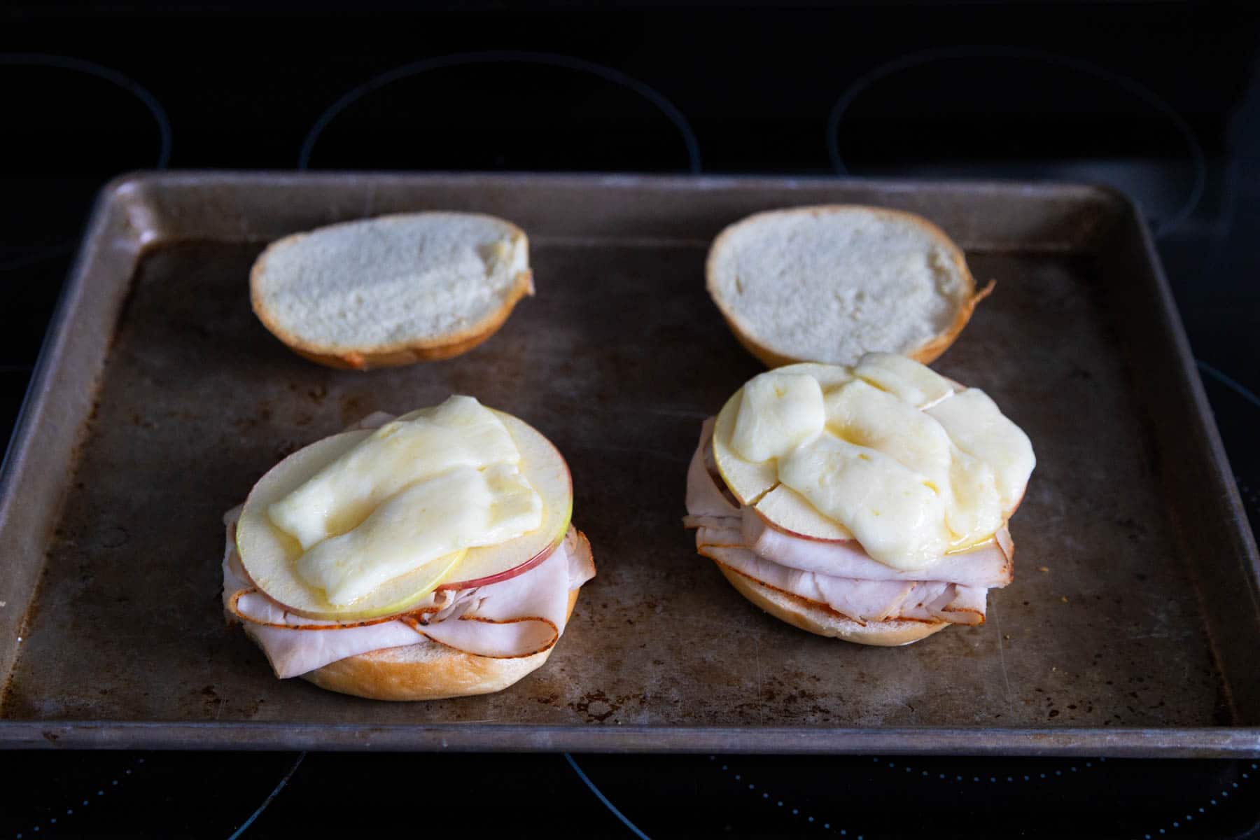 The finished sandwich has just come out of the oven, the brie has melted on top.