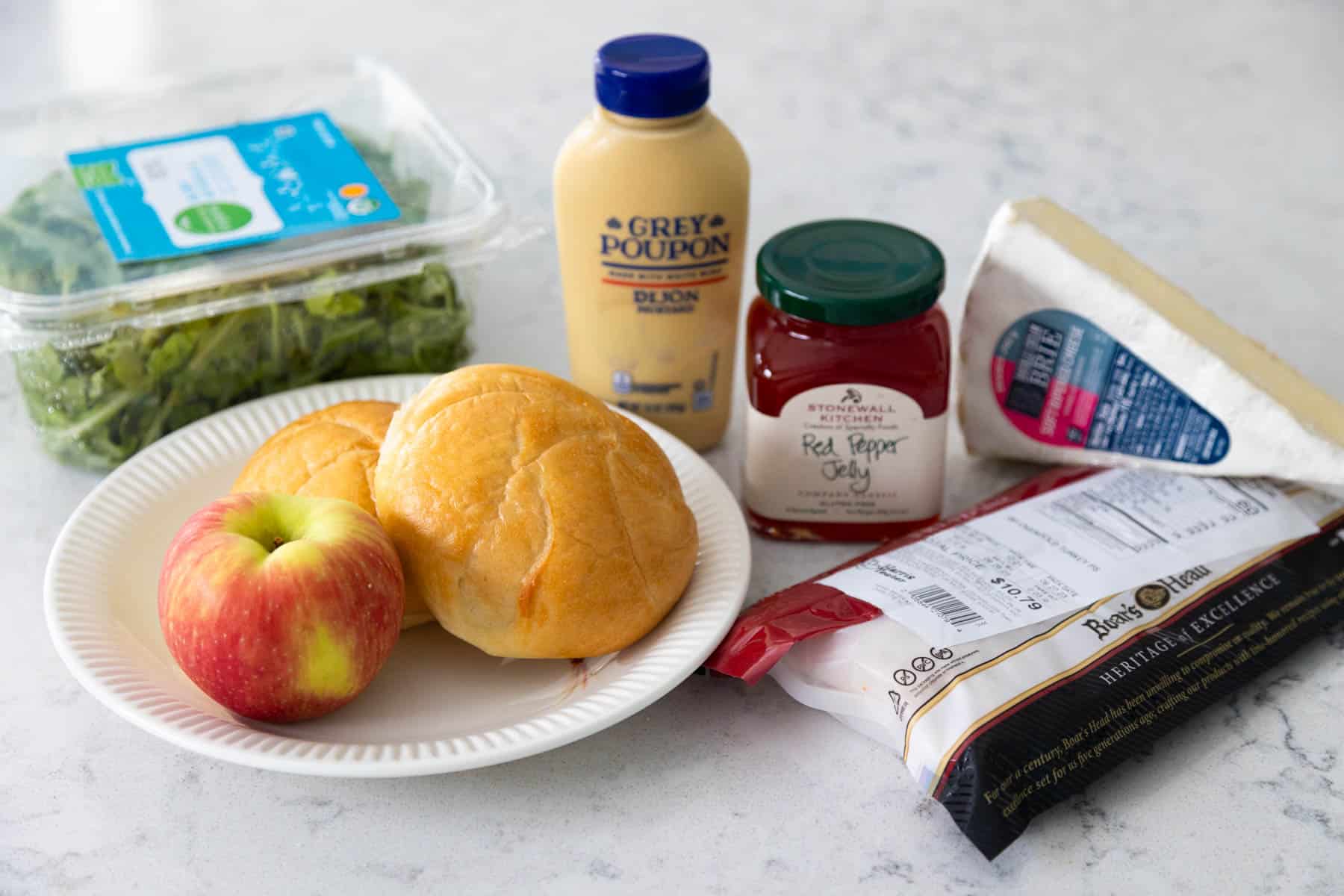 The ingredients to make the turkey sandwich are on the counter.