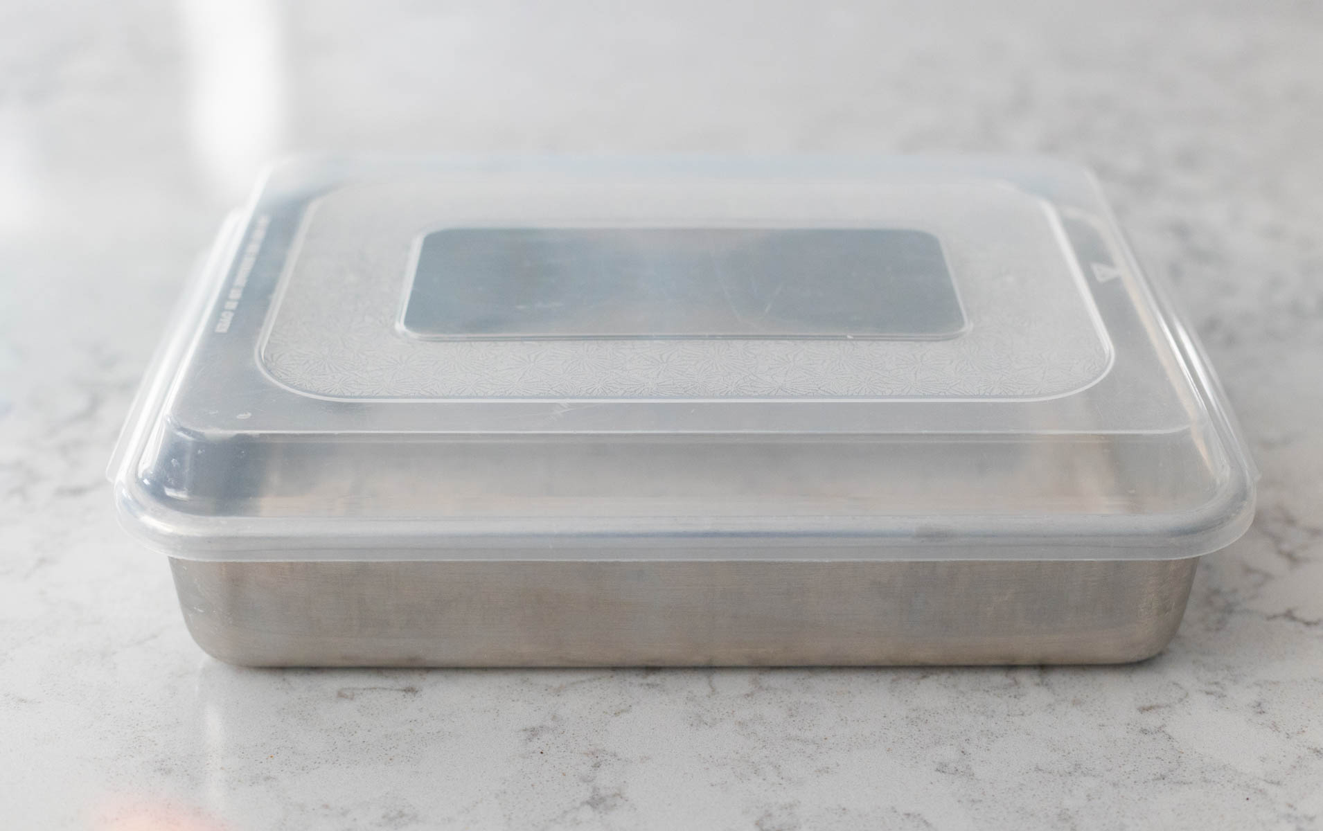 A 9x13-inch baking pan has a plastic lid.