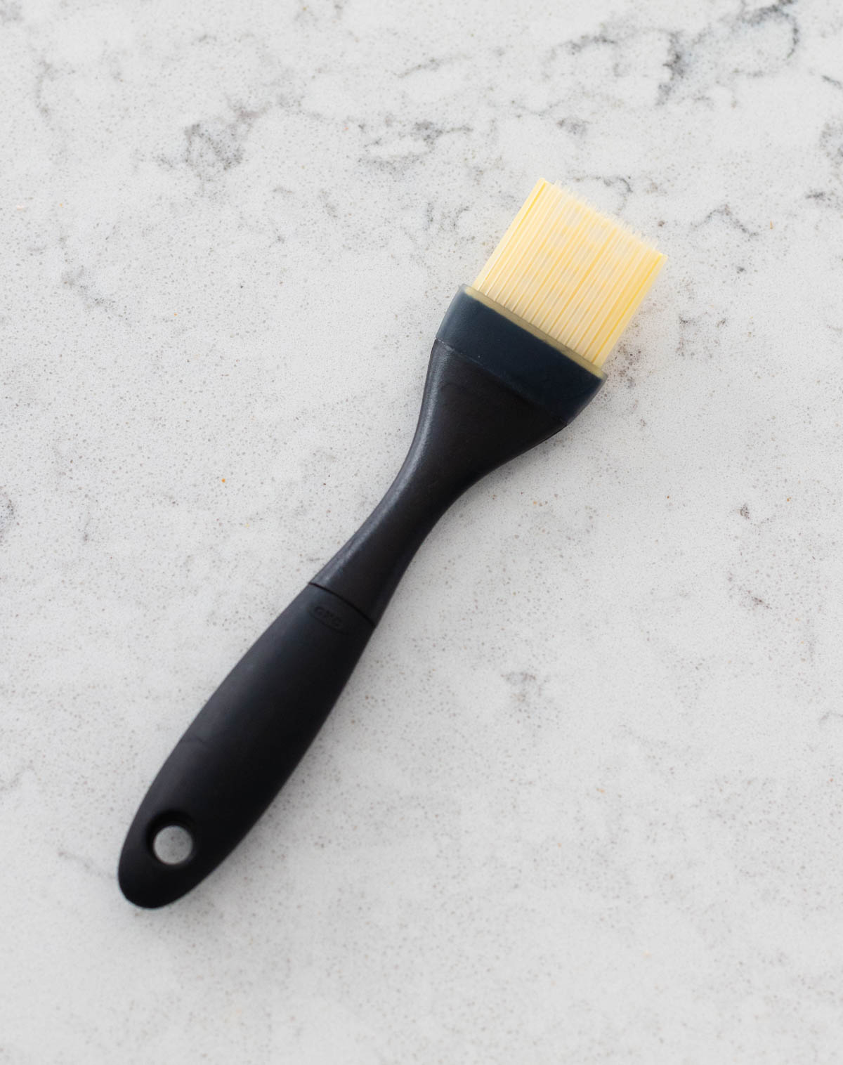 A black silicone pastry brush is on the counter.