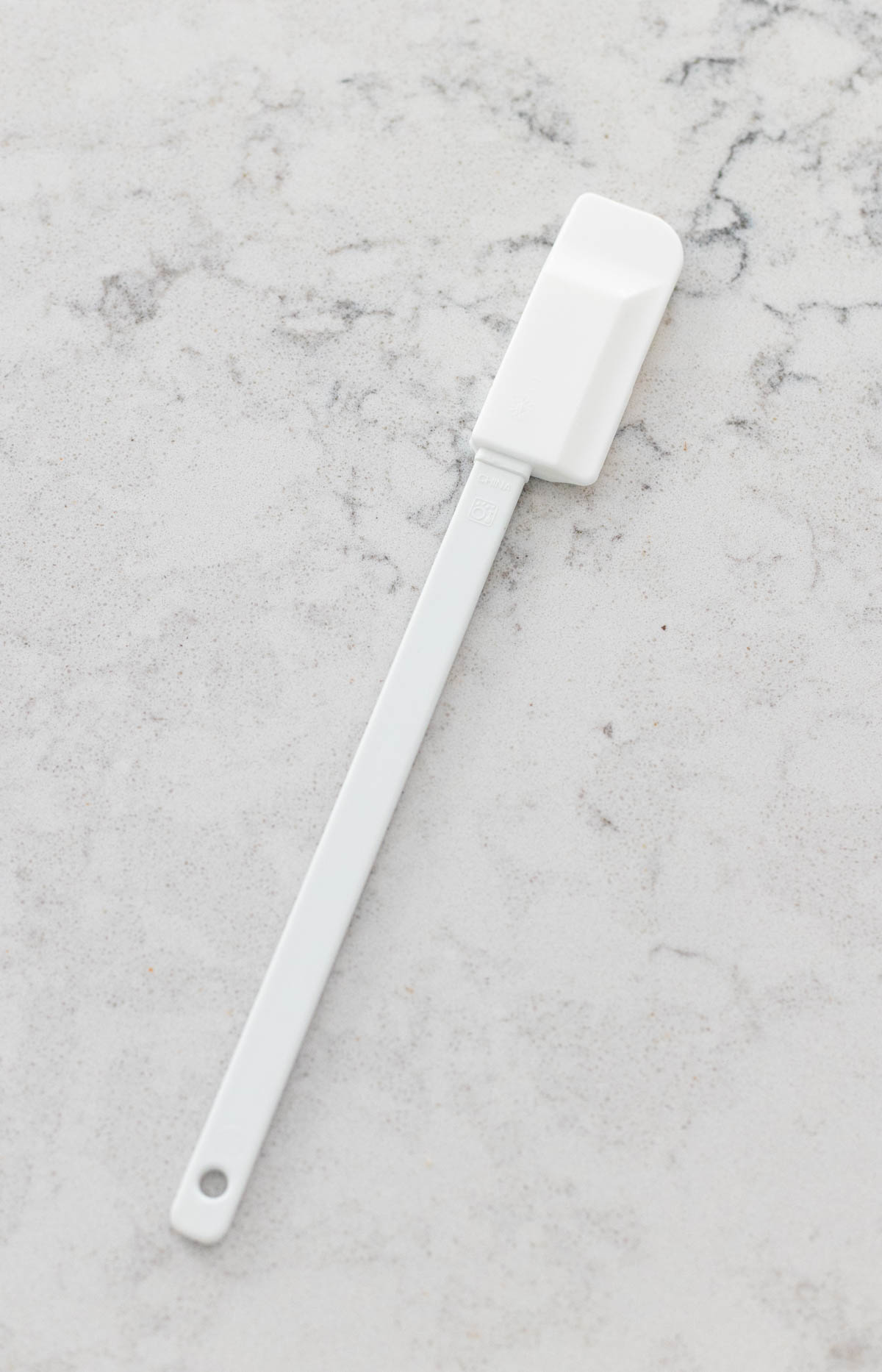 A long handled narrow spatula is on the counter.