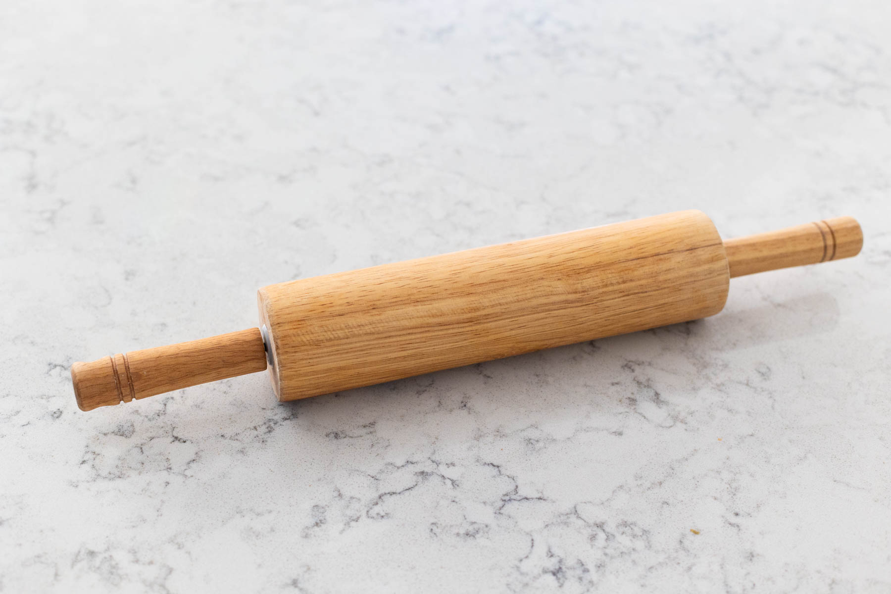 A wooden rolling pin is on the counter.