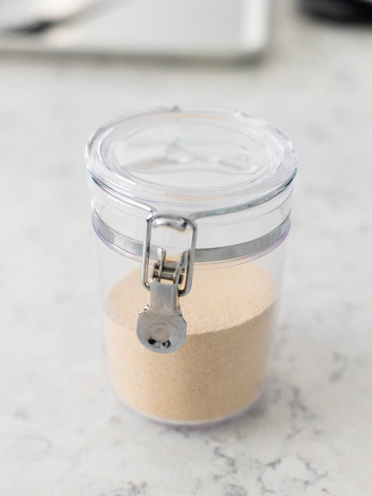 A jar of yeast is on the counter.