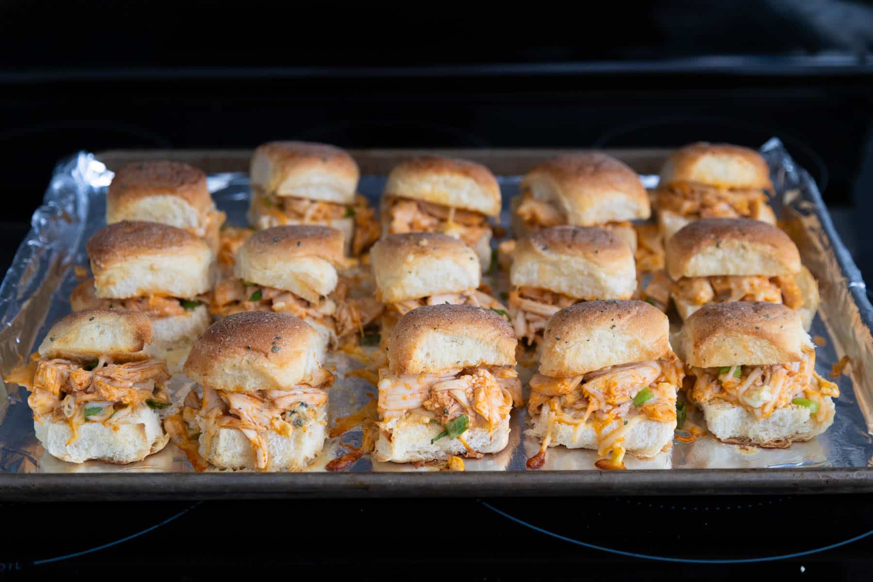 The sliders have just come out of the oven and have golden brown tops.