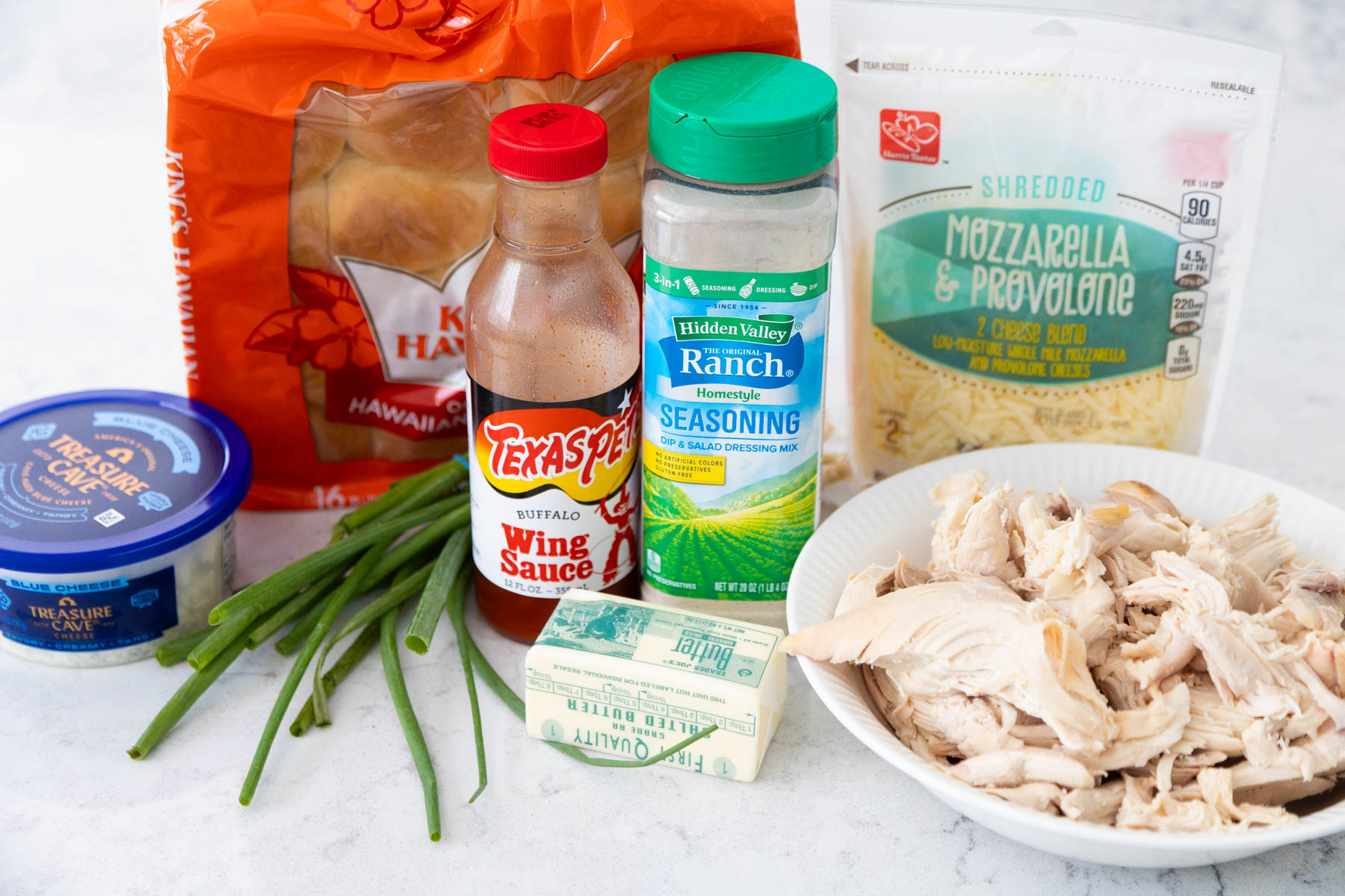 The ingredients to make buffalo chicken sliders are on the kitchen counter.