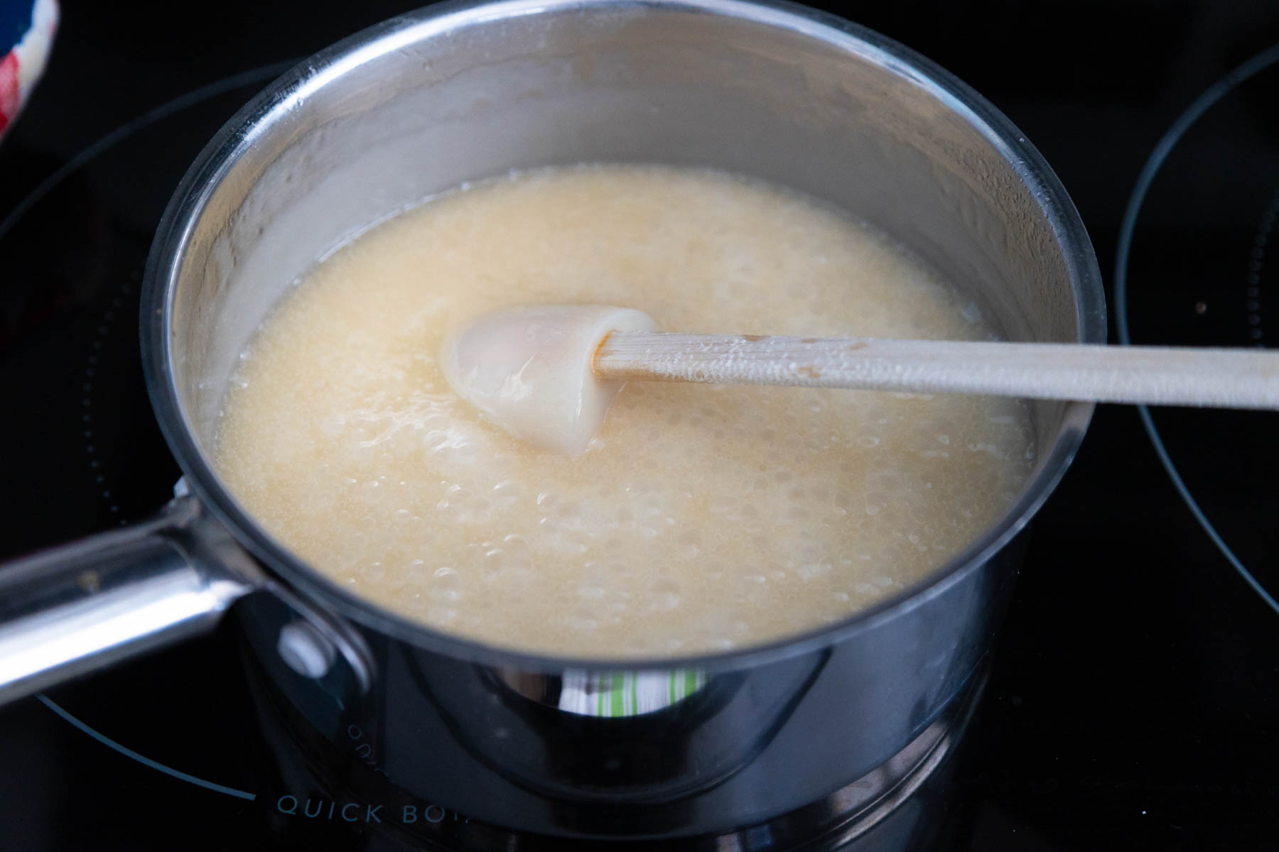The butter and sugar are cooking in a saucepan.