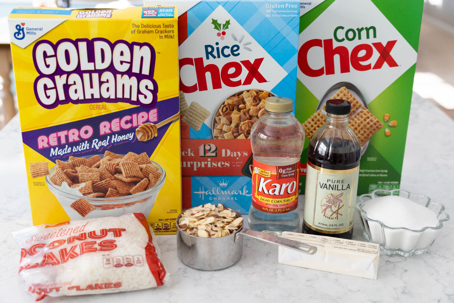 The boxes of cereal and other ingredients to make the Chex Mix are on the counter.