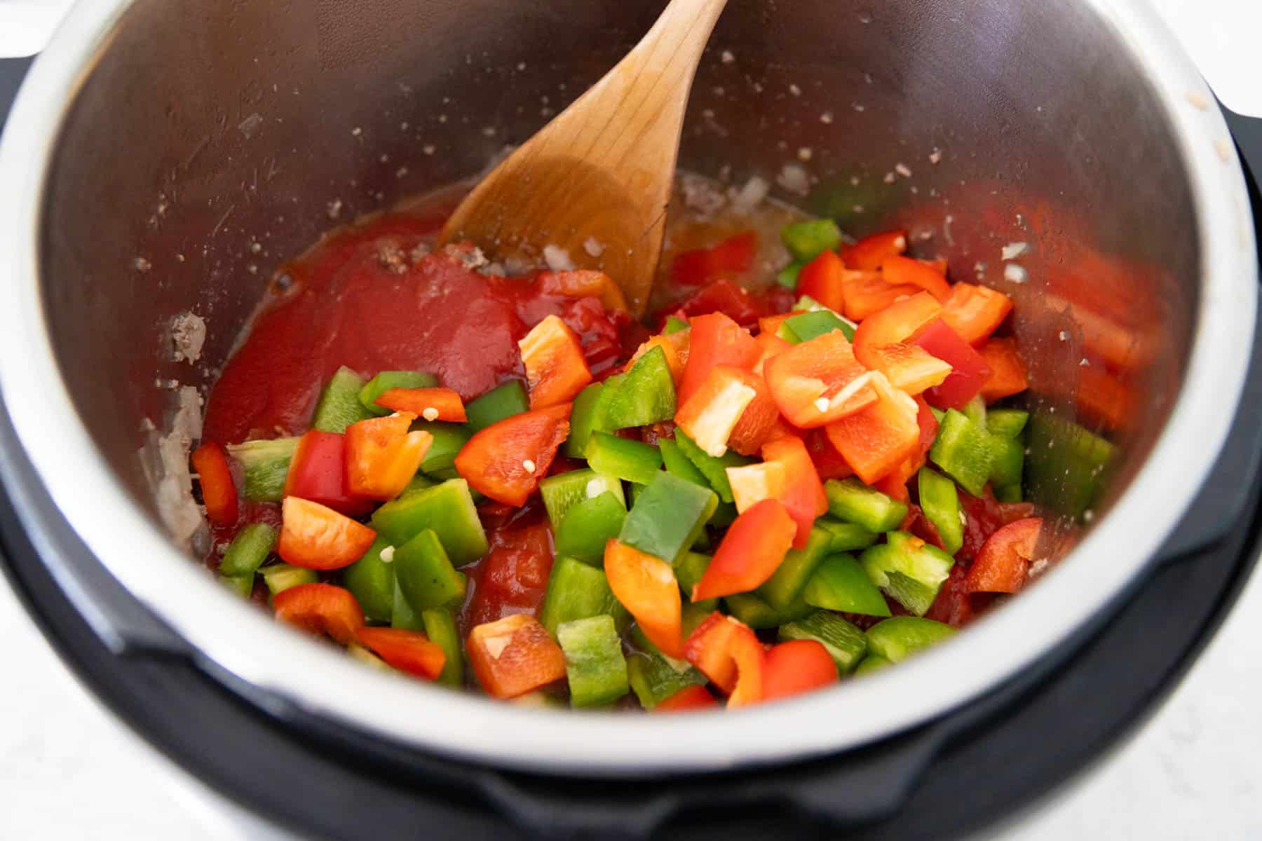 The tomatoes and bell peppers have been added to the Instant Pot.